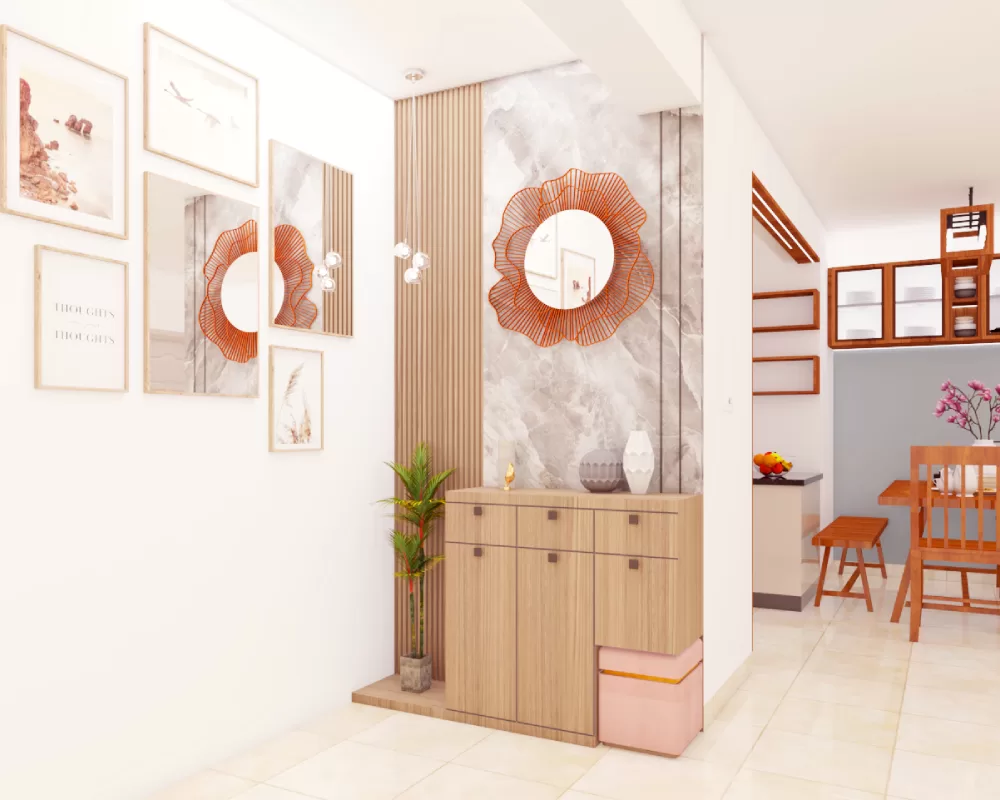Elegant foyer design area featuring decorative mirror wall cabinet, indoor plant, and modern lighting