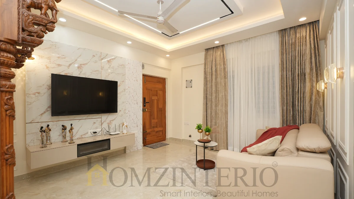Luxury living room in a 2BHK home interior design in Bangalore with marble feature wall and contemporary furniture